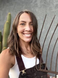 Rebekah of Our Nomadic Homestead holding a pitchfork